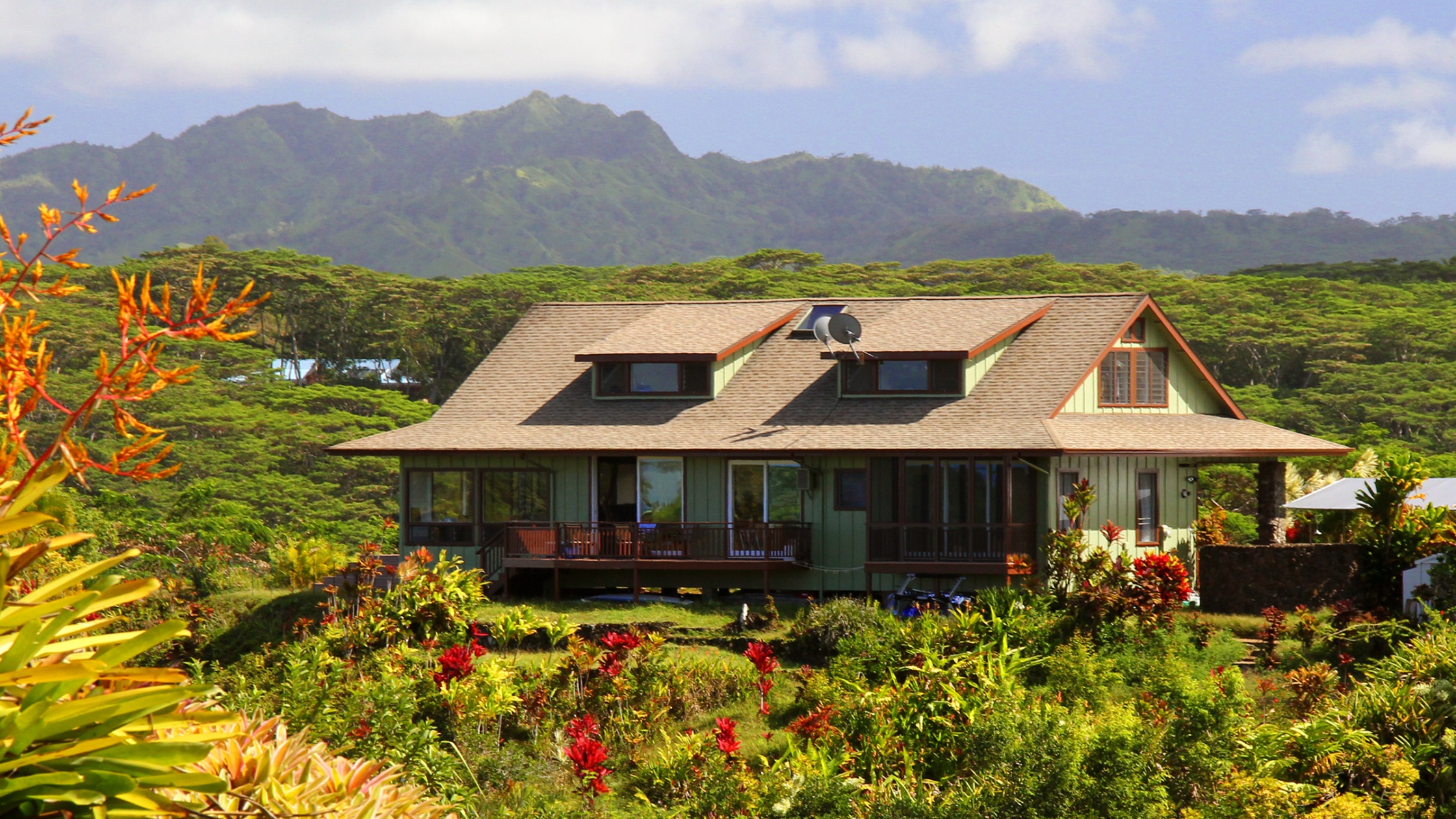 An image of a bungalow with mountains in the background