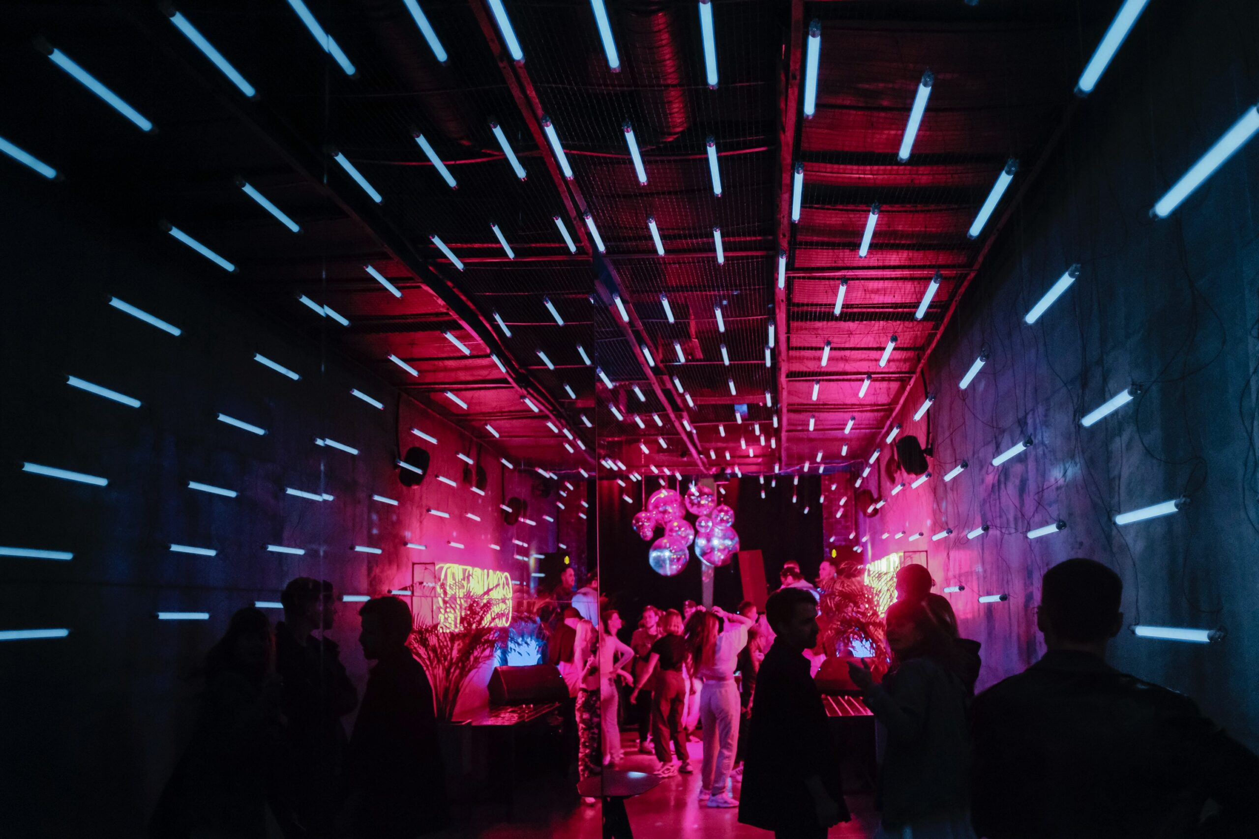 A group of people standing around in a room