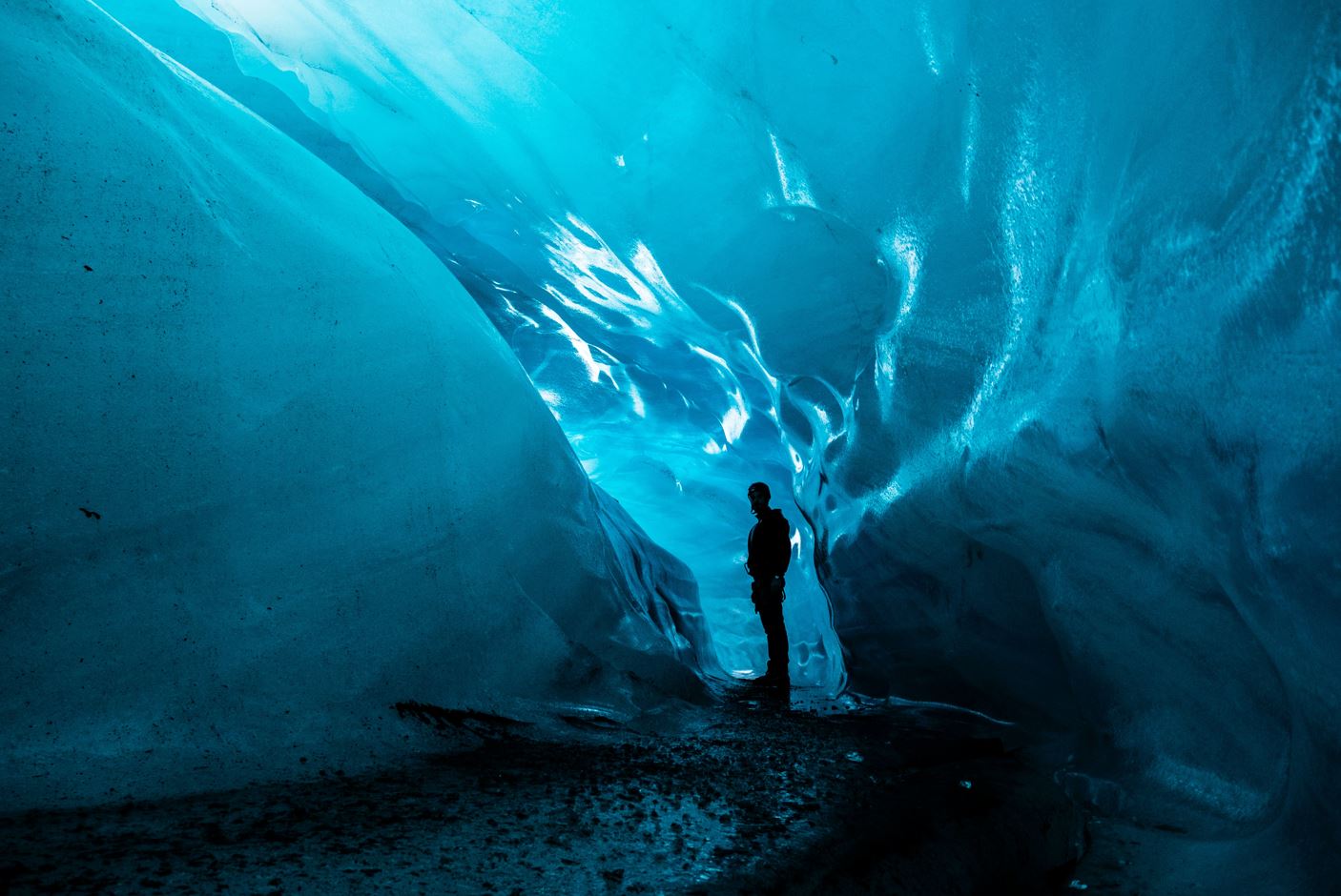 man standing inside a glacier, a unique feature of Iceland's nature