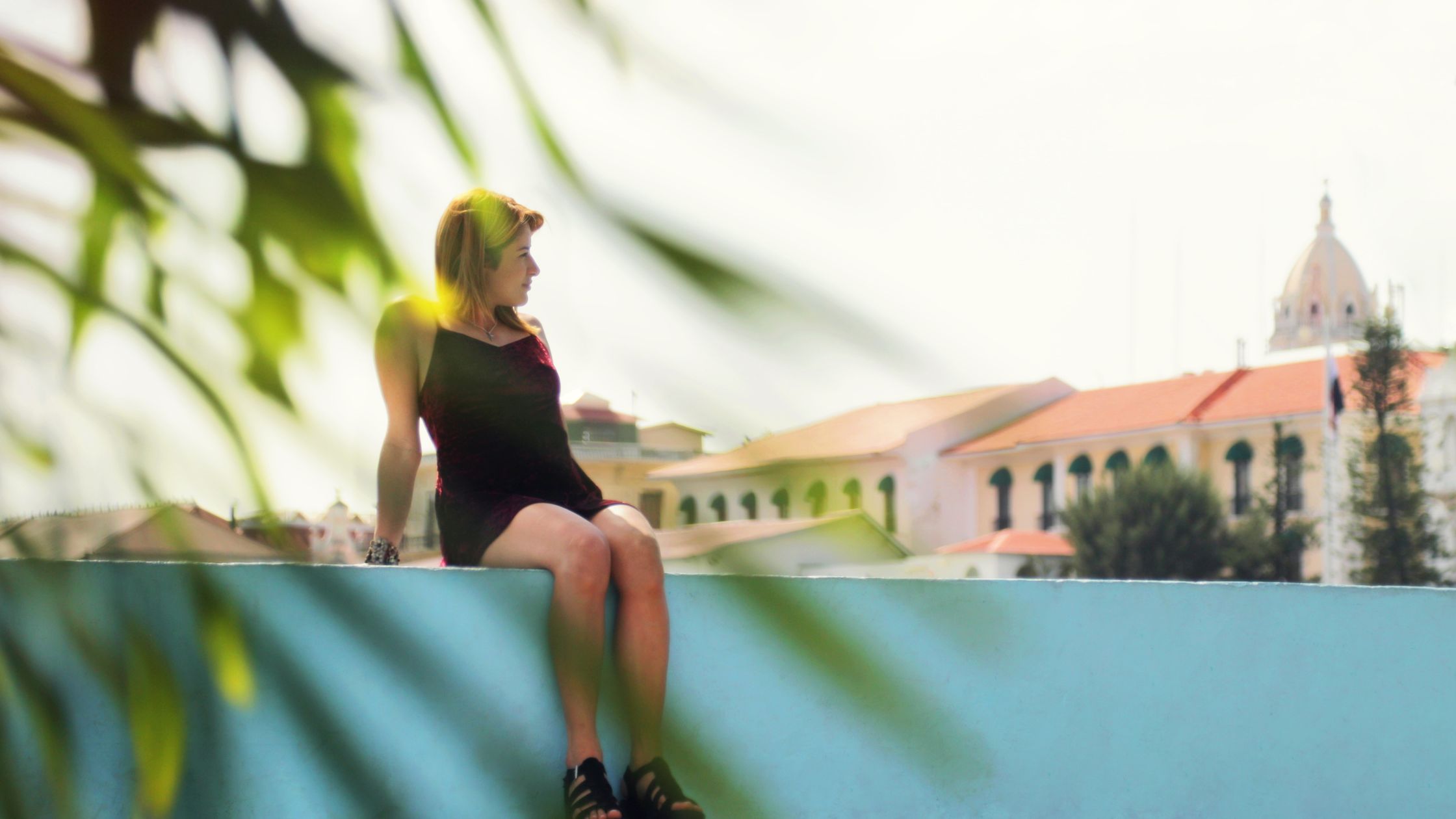A woman sitting on a ledge from her Southern Vacation Rental