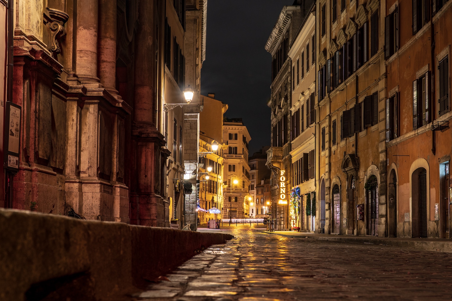 A pavement in between buildings in Rome during the night