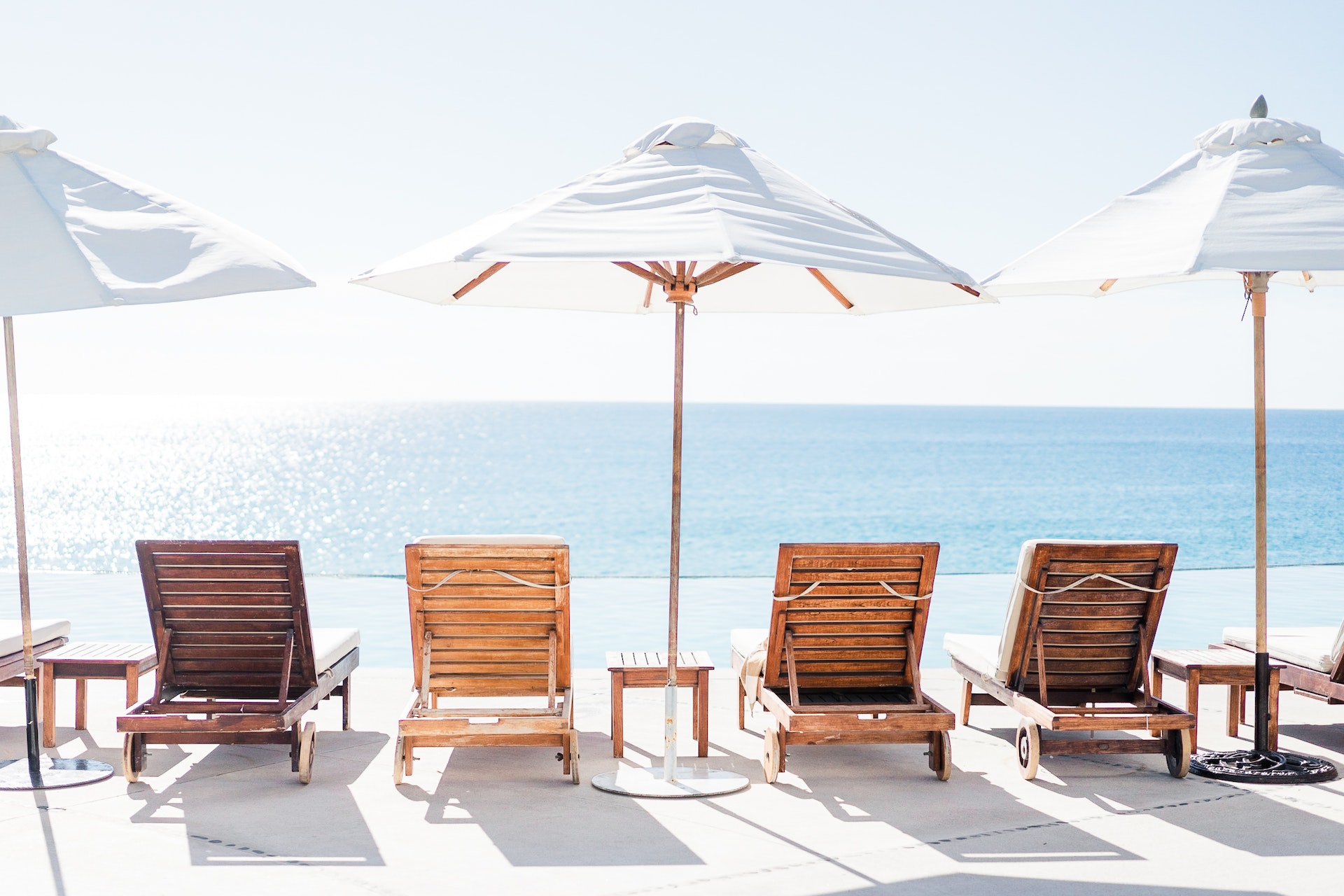 A row of lounge chairs and umbrellas at a Melbourne beach